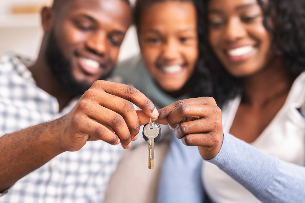 Happy family holding keys on the display